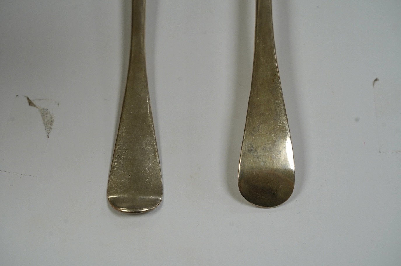 A George I silver Old English pattern table spoon, rubbed maker's mark, London, 1721 and a George III Irish silver table spoon, Dublin, 1760, 136 grams. Condition - fair